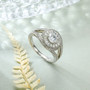 moissanite round bypass double halo ring in rhodium over sterling silver shown in a lifestyle photo