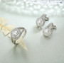 close up of moissanite round bypass double halo ring in rhodium over sterling silver