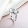 emerald cut moissanite halo ring in rhodium over sterling silver shown in a lifestyle photo