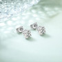 Moissanite 7mm round sterling silver stud earrings live shot