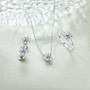 close up of 7mm round moissanite stud earrings in rhodium over sterling silver