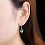 green fluorite dangle earrings in rhodium over sterling silver worn on the ear
