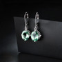 green fluorite dangle earrings in rhodium over sterling silver shown in a lifestyle photo