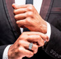 mens moissanite ring in rhodium over sterling silver worn on a hand