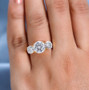 moissanite round trilogy ring in 18k yellow gold over sterling silver worn on a hand