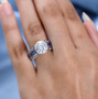 moissanite and tanzanite bridge ring in rhodium over sterling silver worn on a hand