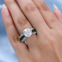 moissanite and chrome diopside bridge ring in rhodium over sterling silver worn on a hand
