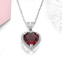 garnet heart and white zircon halo pendant necklace in rhodium over sterling silver shown in a lifestyle photo