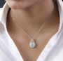round moissanite cluster necklace in rhodium over sterling silver worn around the neck