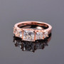 princess cut moissanite five stone band ring in 18k rose gold over sterling silver shown in a lifestyle photo
