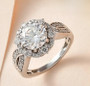 moissanite round halo ring in rhodium over sterling silver shown in a lifestyle photo