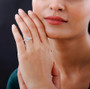 radiant and round moissanite wedding ring in rhodium over sterling silver worn on a hand