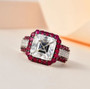 asscher cut moissanite and ruby halo ring in rhodium over sterling silver shown in a lifestyle photo