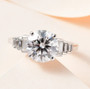 round and baguette moissanite ring in rhodium over sterling silver shown in a lifestyle photo