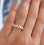 mixed shape moissanite band ring in 10k yellow gold worn on a hand
