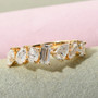 mixed shape moissanite band ring in 10k yellow gold shown in a lifestyle photo
