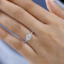 radiant baguette and round cut moissanite wedding ring in 10k white gold worn on a hand