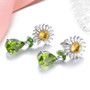 side view of peridot and citrine flower drop earrings in rhodium over sterling silver