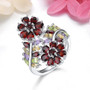 garnet and multi gemstone flower cluster bypass ring in rhodium over sterling silver shown in a lifestyle photo