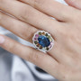 london blue topaz multi tourmaline and zircon ring in rhodium over sterling silver worn on a hand