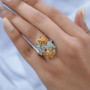 tsavorite garnet spessartine garnet and white zircon bypass ring in rhodium over sterling silver worn on a hand