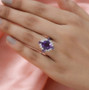 amethyst and white zircon halo ring in rhodium over sterling silver worn on a hand
