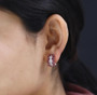 rhodolite garnet and moissanite cluster earrings in 18k rose gold over sterling silver worn on the ear
