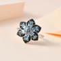 aquamarine and black spinel flower cluster ring in rhodium over sterling silver shown in a lifestyle photo