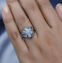 aquamarine and black spinel flower cluster ring in rhodium over sterling silver worn on a hand