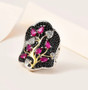 ruby black spinel and zircon cluster ring in 18k yellow gold and rhodium over sterling silver shown in a lifestyle photo