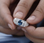 london blue topaz and white zircon mens ring in rhodium over sterling silver shown in a lifestyle photo