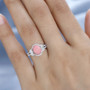 pink opal and moissanite ring in rhodium over sterling silver worn on a hand