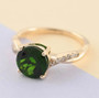 round chrome diopside and diamond ring in 14k yellow gold shown in a lifestyle photo