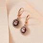 morganite brown and white zircon lever back earrings in 18k rose gold over sterling silver shown in a lifestyle photo