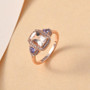 morganite tanzanite and white zircon ring in 18k rose gold over sterling silver shown in a lifestyle photo