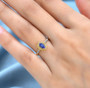 tanzanite yellow sapphire and white zircon halo ring in 18k yellow gold over sterling silver worn on a hand