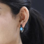 arizona sleeping beauty turquoise and black spinel omega back earrings in rhodium over sterling silver worn on the ear