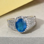 blue apatite and white zircon ring in rhodium over sterling silver shown in a lifestyle photo