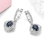 full view of sapphire and white zircon double halo dangle earrings in rhodium over sterling silver