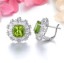 close up of peridot and white zircon ballerina halo stud earrings in rhodium over sterling silver