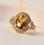 heliodor yellow sapphire and moissanite halo ring in 18k yellow gold over sterling silver shown in a lifestyle photo