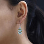 blue apatite peridot and zircon lever back earrings in rhodium over sterling silver worn on the ear