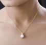 pink opal and moissanite pendant necklace in 18k yellow gold over sterling silver worn around the neck
