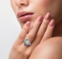 ethiopian opal tanzanite and white zircon halo ring in rhodium over sterling silver worn on a hand