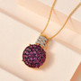 rhodolite garnet and white zircon pendant necklace in 18k yellow gold over sterling silver shown in a lifestyle photo