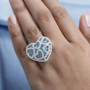 blue apatite and moissanite heart ring in rhodium over sterling silver worn on a hand