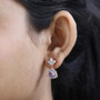 rose de france amethyst and moissanite dangle earrings in 18k rose gold over sterling silver worn on the ear