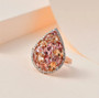pink tourmaline imperial topaz and moissanite pear cluster ring in 18k rose gold over sterling silver shown in a lifestyle photo