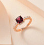rhodolite garnet and moissanite ring in 18k rose gold over sterling silver shown in a lifestyle photo
