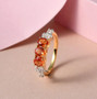 orange sapphire and white zircon ring in 18k yellow gold over sterling silver shown in a lifestyle photo